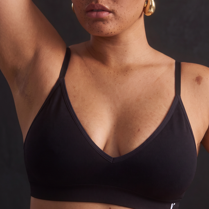 Black Rudie bralette shown in a studio campaign portrait.
